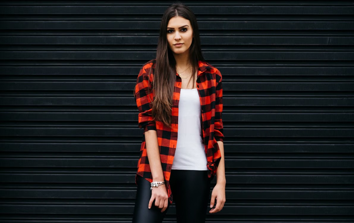Man wearing one of several flannel outfit ideas with a graphic tee and jacket