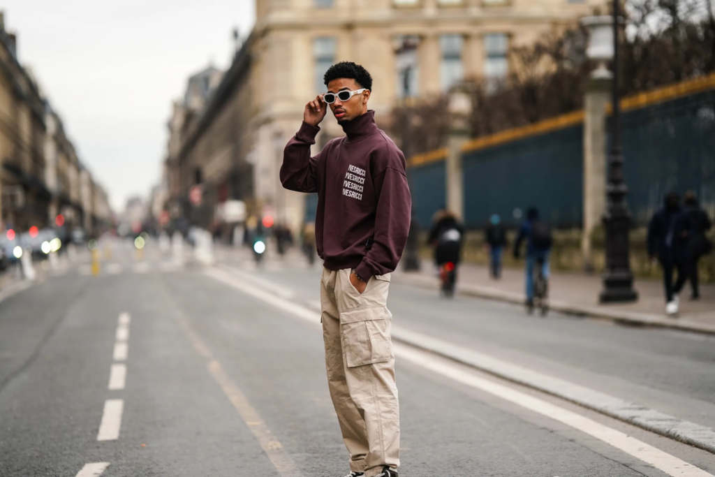 Man showing how to style cargos with a knit hoodie and derby shoes