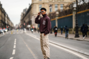 Man showing how to style cargos with a knit hoodie and derby shoes