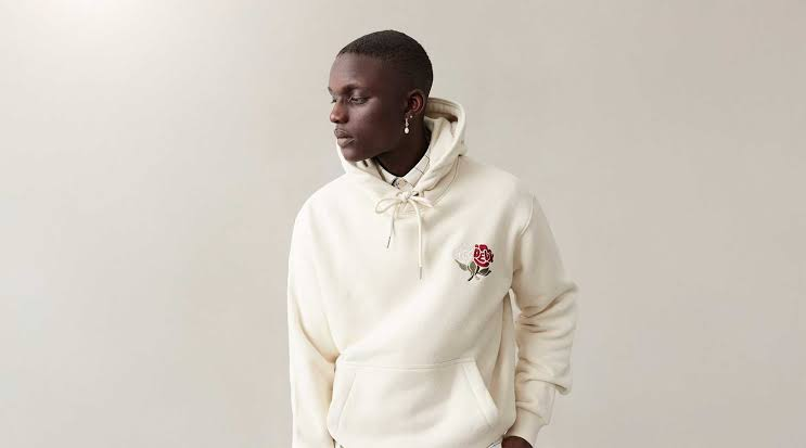 Man showing how to style a hoodie with cargo pants and sneakers in 2026