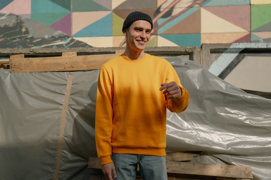 Man styling crewneck sweatshirts with denim and a jacket